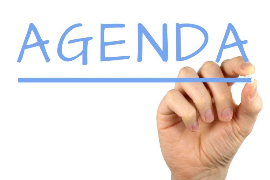 Image showing the word agenda with a hand underlining it.